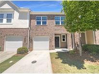 Charming brick townhouse with a one-car garage and inviting entrance at 1958 Millstream Holw, Conyers, GA 30012