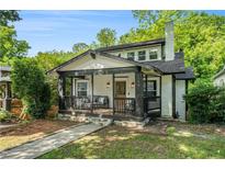 Charming home with a cozy front porch, stone foundation and a manicured lawn at 1227 Epworth Sw St, Atlanta, GA 30310