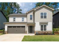 Charming two-story home features a two-car garage and beautifully landscaped front yard at 2428 Mills Bnd, Decatur, GA 30034