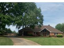 Lovely one-story brick home with a manicured lawn and a private driveway leading to a gated entrance at 5950 Meadow Brook Ln, Cumming, GA 30040
