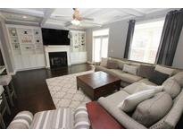 Comfortable living room with a large sectional sofa, fireplace, and built-in shelving at 116 Festoon Ct, Smyrna, GA 30080