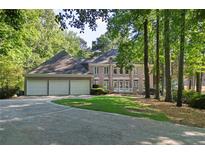 Beautiful brick home with a three-car garage and a well-manicured lawn and landscape at 181 Sentinel Pl, Marietta, GA 30067