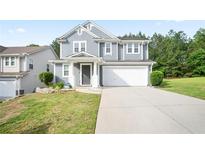 Inviting two-story home with a well-maintained lawn, a two-car garage, and classic curb appeal at 2210 Valley Creek Dr, Lithia Springs, GA 30122