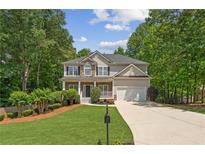 Charming two-story home with a well-maintained lawn, two-car garage, and inviting front porch at 84 Conner Glenn Dr, Hiram, GA 30141