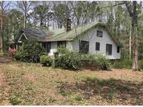 Traditional home exterior with mature trees offering shade and privacy at 650 Sage St, Temple, GA 30179