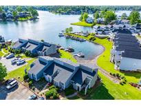 Stunning aerial view of waterfront homes, showcasing boat docks and serene lake vistas at 325 Berry Ct, Villa Rica, GA 30180