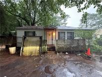 Modest one-story home with a small front porch and mature trees at 3448 Orchard Cir, Decatur, GA 30032