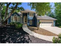 Charming blue two-story home with manicured front yard and inviting walkway at 4915 Bayberry Dr, Cumming, GA 30040