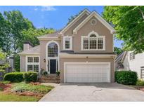 Charming home with a two-car garage, beautiful landscaping, and a welcoming front entrance at 5065 Harbour Ridge Dr, Alpharetta, GA 30005
