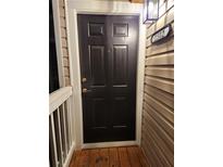 A six-panel black front door with white trim and the unit number displayed on the building at 1502 Countryside Se Pl # 1502, Smyrna, GA 30080