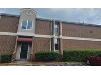 Brick exterior elevation featuring a red awning, and trimmed with white accents at 3301 Henderson Mill Rd # J1, Atlanta, GA 30341