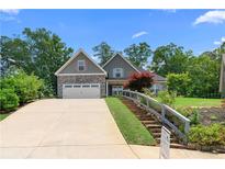 Charming two-story home with stone accents, a two-car garage, and landscaped front yard at 114 Brookstone Dr, Carrollton, GA 30116