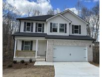Charming two-story home featuring a brick facade, white siding, and a spacious two-car garage at 528 Earnest Ln, Temple, GA 30179