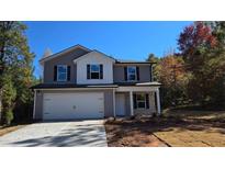 Two-story home with gray siding, white trim, black shutters, and a spacious two-car garage at 127 Deer Xing, Temple, GA 30179