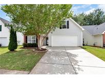 Charming home featuring a two-car garage and a well-maintained front yard with mature landscaping at 285 Kentshire Pl, Lawrenceville, GA 30044