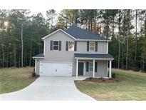 Charming two-story home featuring a covered porch, two-car garage, and landscaped front yard at 836 Courthouse Park Dr, Temple, GA 30179