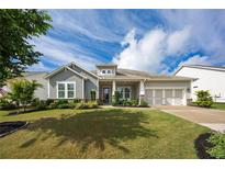Charming single-Gathering home with a manicured lawn, gray siding, and a two-car garage at 250 Cordova St, Woodstock, GA 30189