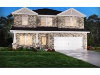 Charming two-story home featuring a stone facade and a spacious two-car garage at 6920 Chester St, Fairburn, GA 30213
