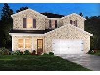 Two-story home featuring a brick facade, a two-car garage, and a well-manicured lawn at 6921 Chester St, Fairburn, GA 30213