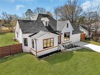 Charming home with a well-manicured lawn and a newly installed horizontal fence at 1774 Vesta Ave, Atlanta, GA 30337