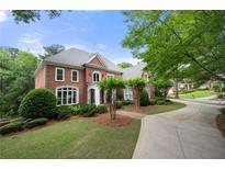 Elegant brick home featuring a well-manicured lawn and a curved driveway leading to the entrance at 2743 Long Grove Dr, Marietta, GA 30062