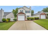 Charming two-story home featuring a brick-accented garage and manicured lawn at 3979 White Owl Nw Ct, Duluth, GA 30097