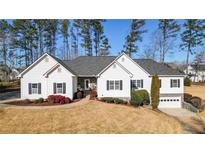 Beautiful single-story home with manicured front lawn, enhanced by the well-kept landscaping and charming details at 6218 Old Stilesboro Nw Rd, Acworth, GA 30101