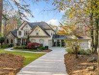 Charming two-story home with stone accents, attached garage, and manicured lawn at 8170 Hurakan Creek Xing, Cumming, GA 30028