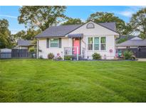Charming home featuring a well-manicured lawn, complemented by decorative accents and a pink front door at 892 Wayland Ct, Smyrna, GA 30080