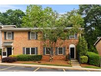 Charming brick townhouse with well-maintained landscaping and dark shutters at 111 Northdale Pl, Lawrenceville, GA 30046