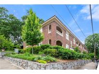 Charming brick building with landscaped greenery and beautiful stone retaining wall at 960 Taft Ne Ave # 9, Atlanta, GA 30309