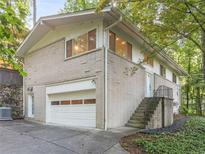 Exterior of a two-story brick home with a two-car garage and landscaping at 1583 Nantahalla Ne Ct, Atlanta, GA 30329