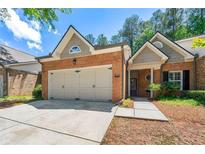 Charming brick home featuring a two-car garage, well-maintained landscaping, and inviting front porch at 3219 Abbott Dr # 5, Powder Springs, GA 30127