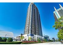 An impressive high-rise condo building with many windows and balconies, set against a clear blue sky in an urban setting at 270 17Th Nw # 1608, Atlanta, GA 30363