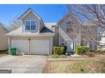 Charming two-story home featuring a two-car garage, landscaped front yard, and welcoming entrance at 2903 Ward Lake Way, Ellenwood, GA 30294