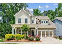 Charming two-story home with a beautifully landscaped front yard and attached garage at 2434 Soft Maple St, Atlanta, GA 30360