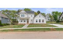 Charming two-story home with a welcoming front porch and a well-manicured lawn at 4060 Andover Cir, Mcdonough, GA 30252