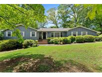 Charming one-story home with beautiful landscaping and mature trees in a lovely neighborhood at 3770 Clubland Trl, Marietta, GA 30068