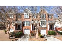 Charming brick townhome with well-manicured landscaping and inviting curb appeal at 4766 Longcourt Se Dr # 23, Atlanta, GA 30339
