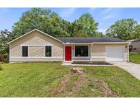 Charming one-story home with a bright red front door and a well-maintained front yard at 4912 Bayside Ct, Stone Mountain, GA 30088