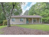 Charming single-story home with a well-maintained lawn and mature trees providing shade and curb appeal at 510 Pineland Sw Rd, Mableton, GA 30126