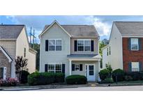 Charming two-story home featuring a welcoming front porch and neatly trimmed hedges at 3142 Imperial Sw Cir, Atlanta, GA 30311