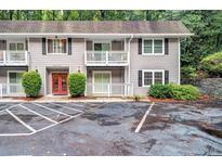 Condominium with gray siding, black shutters, balconies, and parking at 3142 Reeves Se St, Smyrna, GA 30080