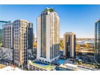 High-rise condo building with pool, tennis court, and stunning city views on a clear, sunny day at 1280 W Peachtree Nw St # 2409, Atlanta, GA 30309
