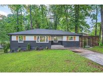 Charming single-story home featuring a well-manicured lawn and unique exterior design at 1722 San Gabriel Ave, Decatur, GA 30032