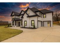 Stunning two-story home boasting modern black and white design and an expansive driveway at 481 Saddle Ridge Dr, Lawrenceville, GA 30046