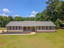 Charming ranch-style home with a covered front porch and well-maintained lawn at 70 Heritage Way, Covington, GA 30016