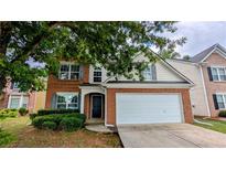 Charming brick-front home featuring a two-car garage and well-maintained landscaping at 2153 Pine View Trl, Ellenwood, GA 30294
