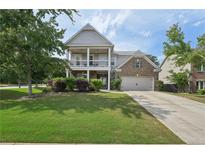 Charming two-story home featuring a double-decker porch, well-maintained lawn, and inviting curb appeal at 251 Parc Dr, Canton, GA 30114