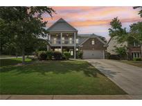 Charming two-story home with a well-manicured lawn and inviting front porch at 251 Parc Dr, Canton, GA 30114